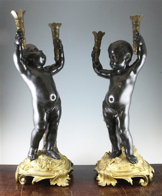A pair of late 19th / early 20th century French bronze and ormolu torcheres, 28.75in.